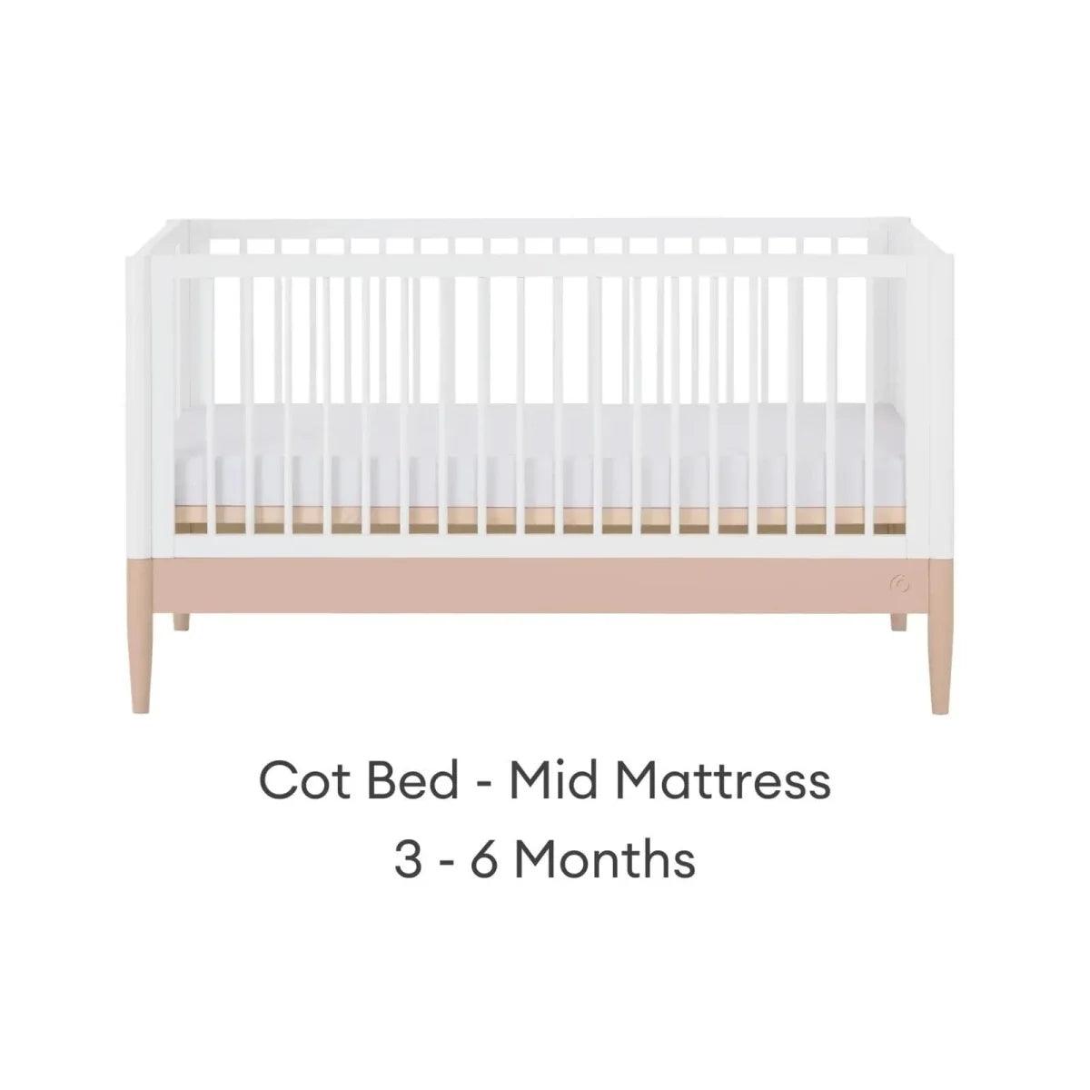 White cot bed with blush mattress band in mid position