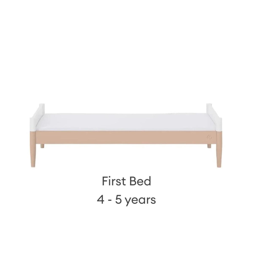 White first bed with blush mattress band