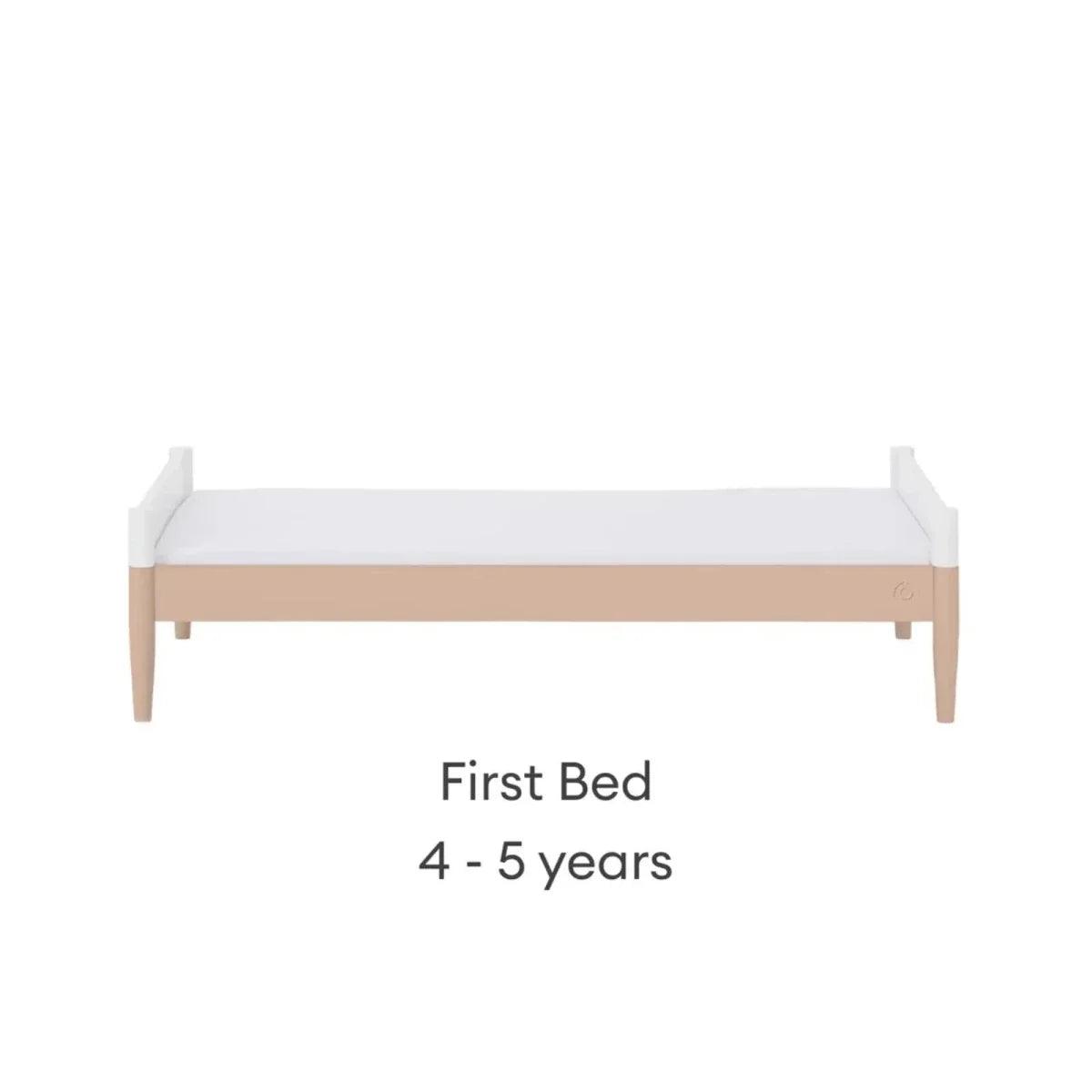 White first bed with blush mattress band
