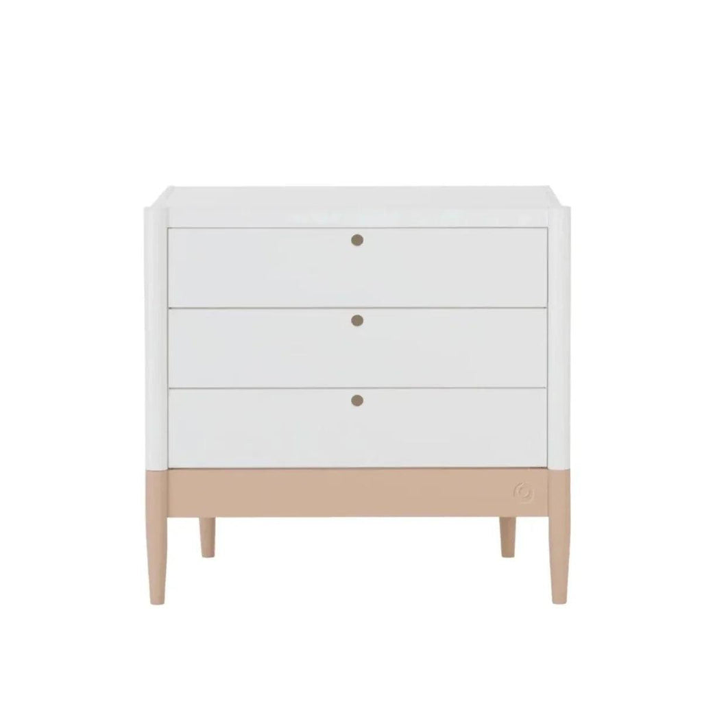 White dresser with three drawers and blush base, round gold knobs