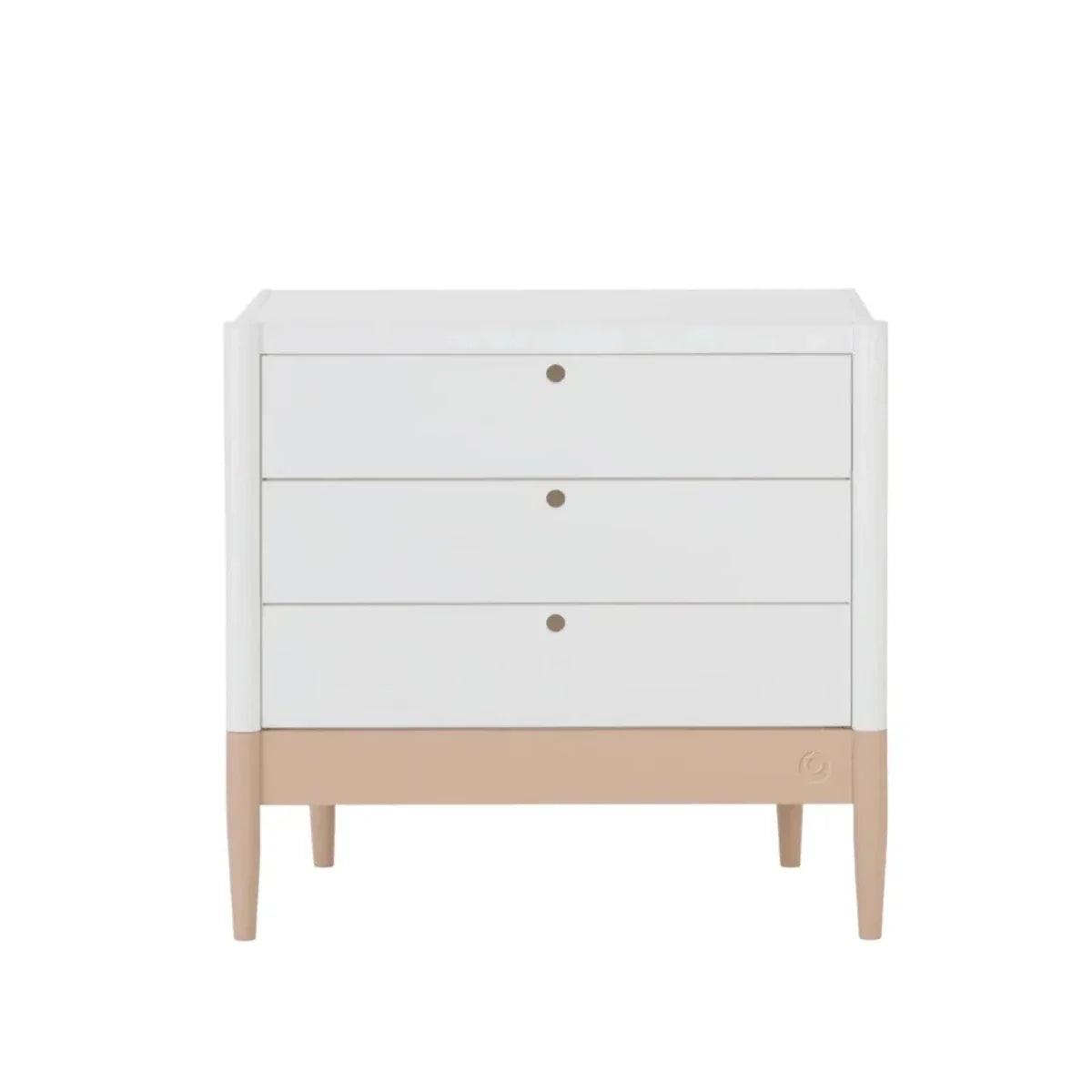 White dresser with three drawers and blush base, round gold knobs
