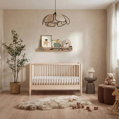 Natural ash baby cot bed with vertical slat sides and low guard rails