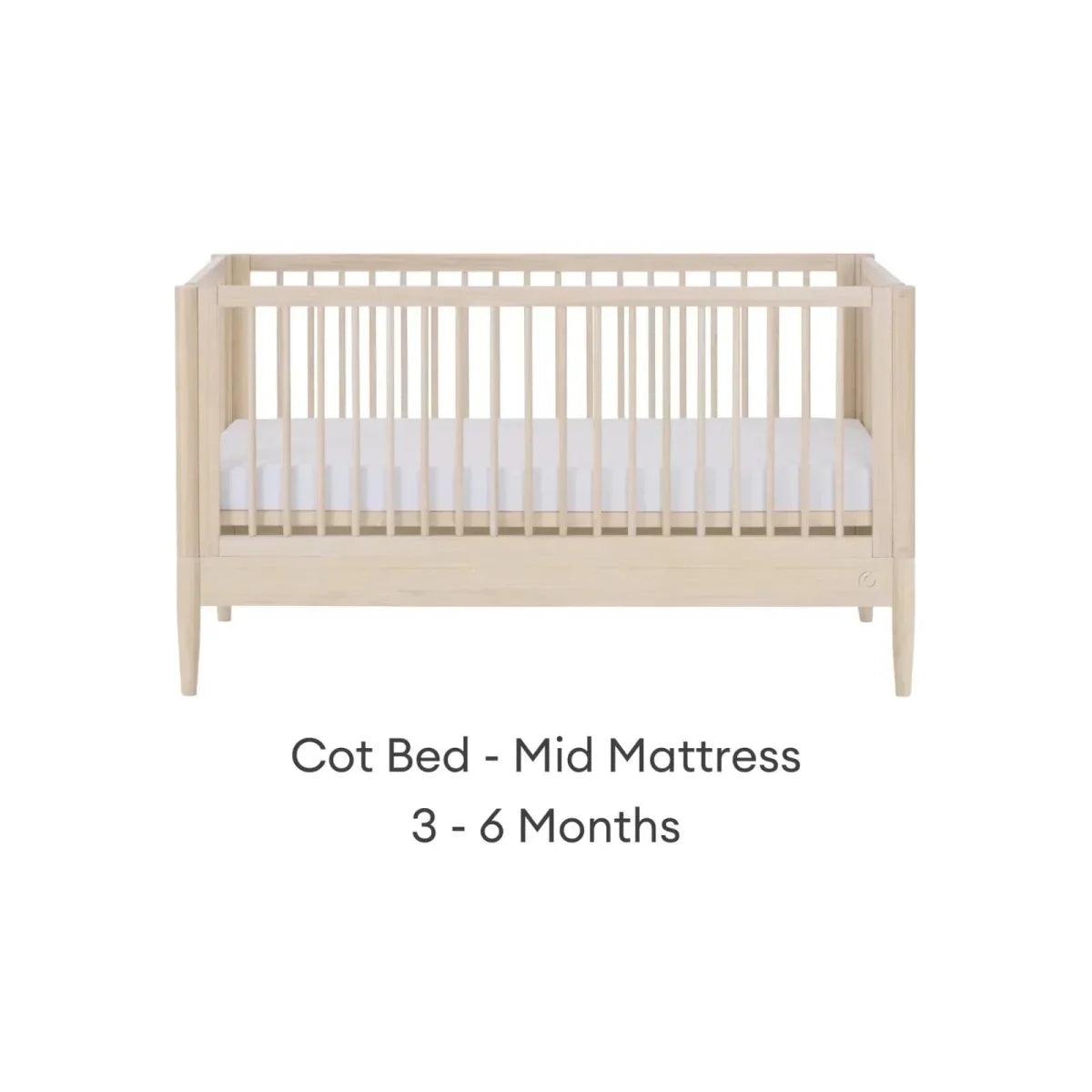 Natural ash cot bed with mid mattress position and slatted guard rails
