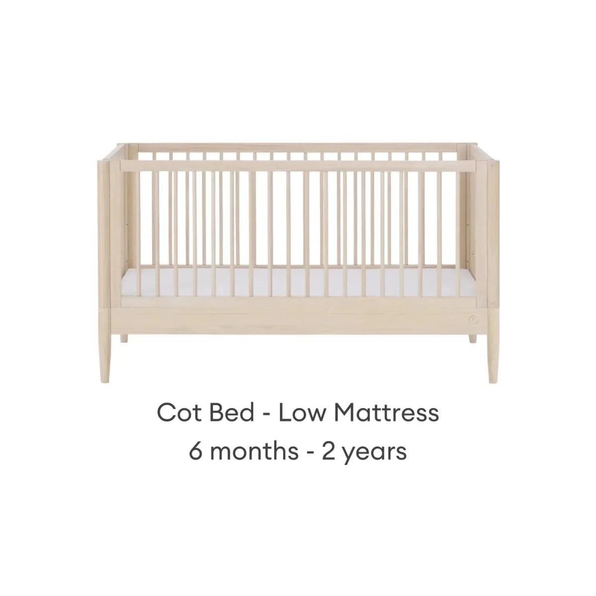 Natural ash cot bed with low mattress position and slatted guard rails