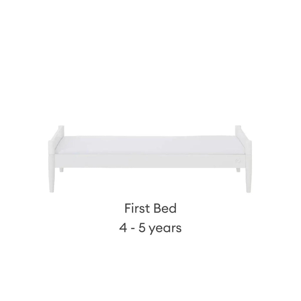 White first bed with low side rails and vertical slat headboard