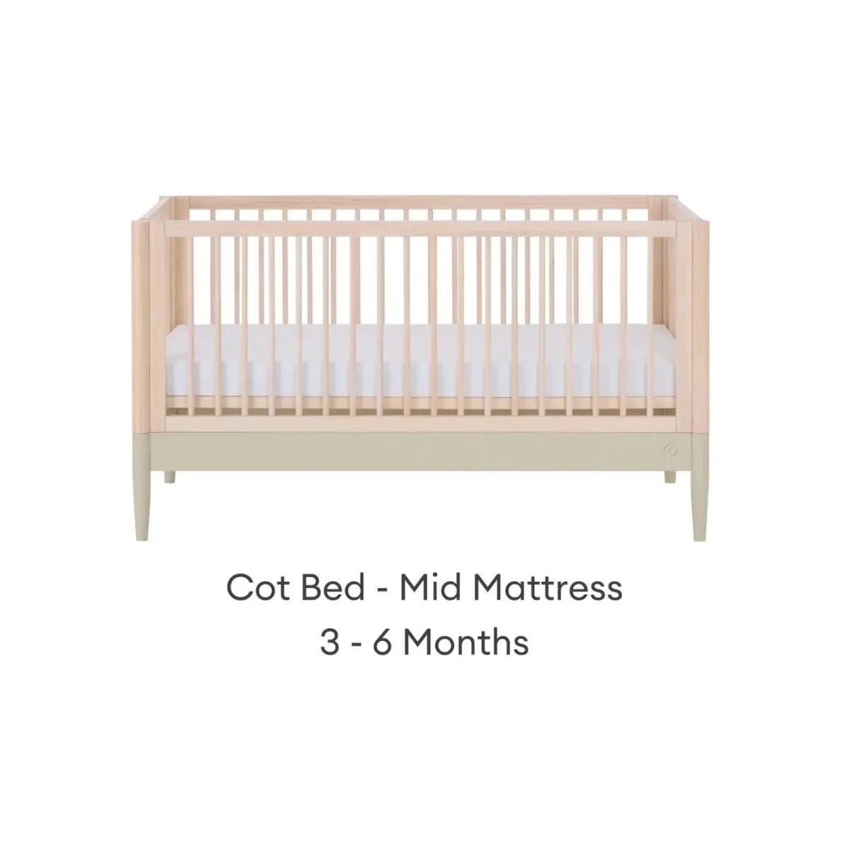 Cot bed in mid mattress position, natural wood frame with desert sage lower panel