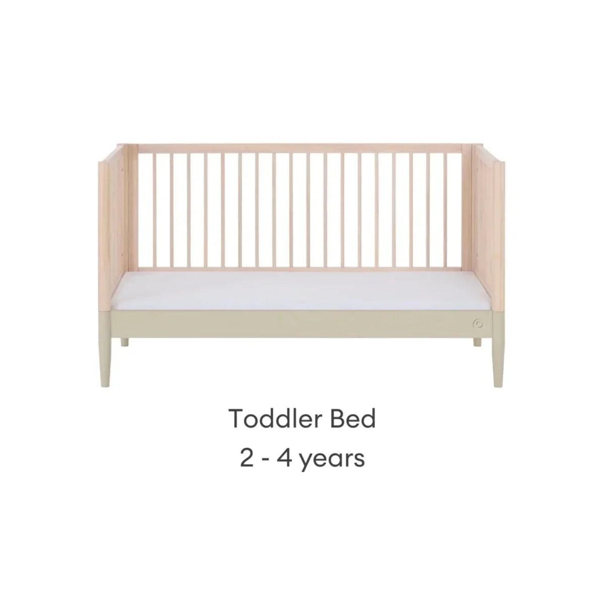 Toddler bed conversion, natural wood frame with vertical slat ends and desert sage base