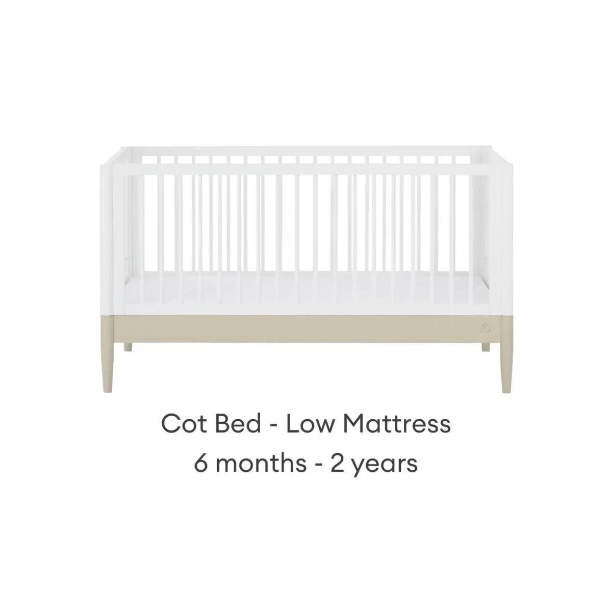 White cot bed with low mattress position and vertical slat rail