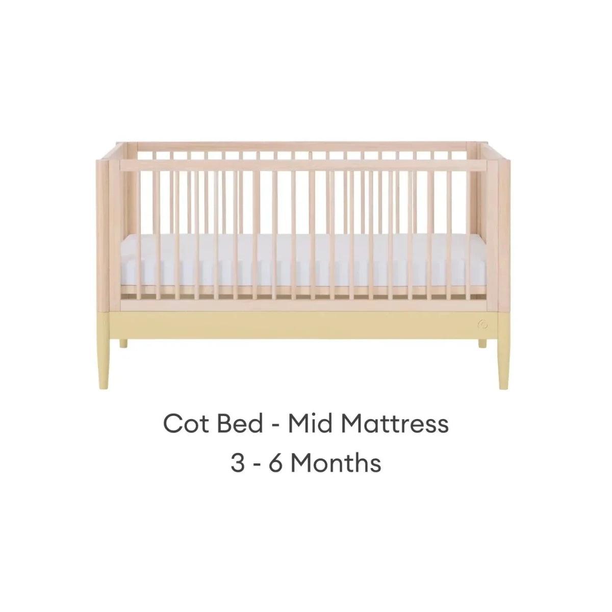 Cot bed frame in natural wood with primrose yellow panel and mid mattress position