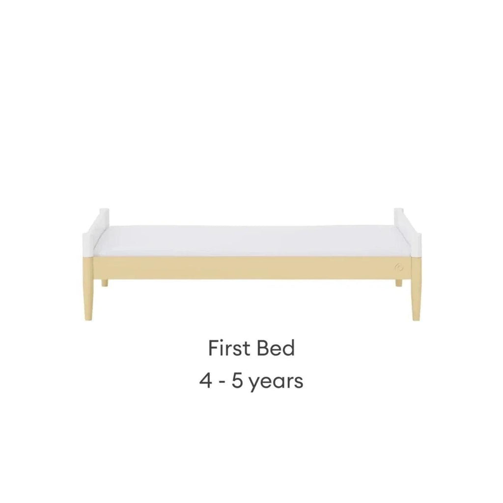 First bed with white side panels, primrose yellow trim, and light wood legs