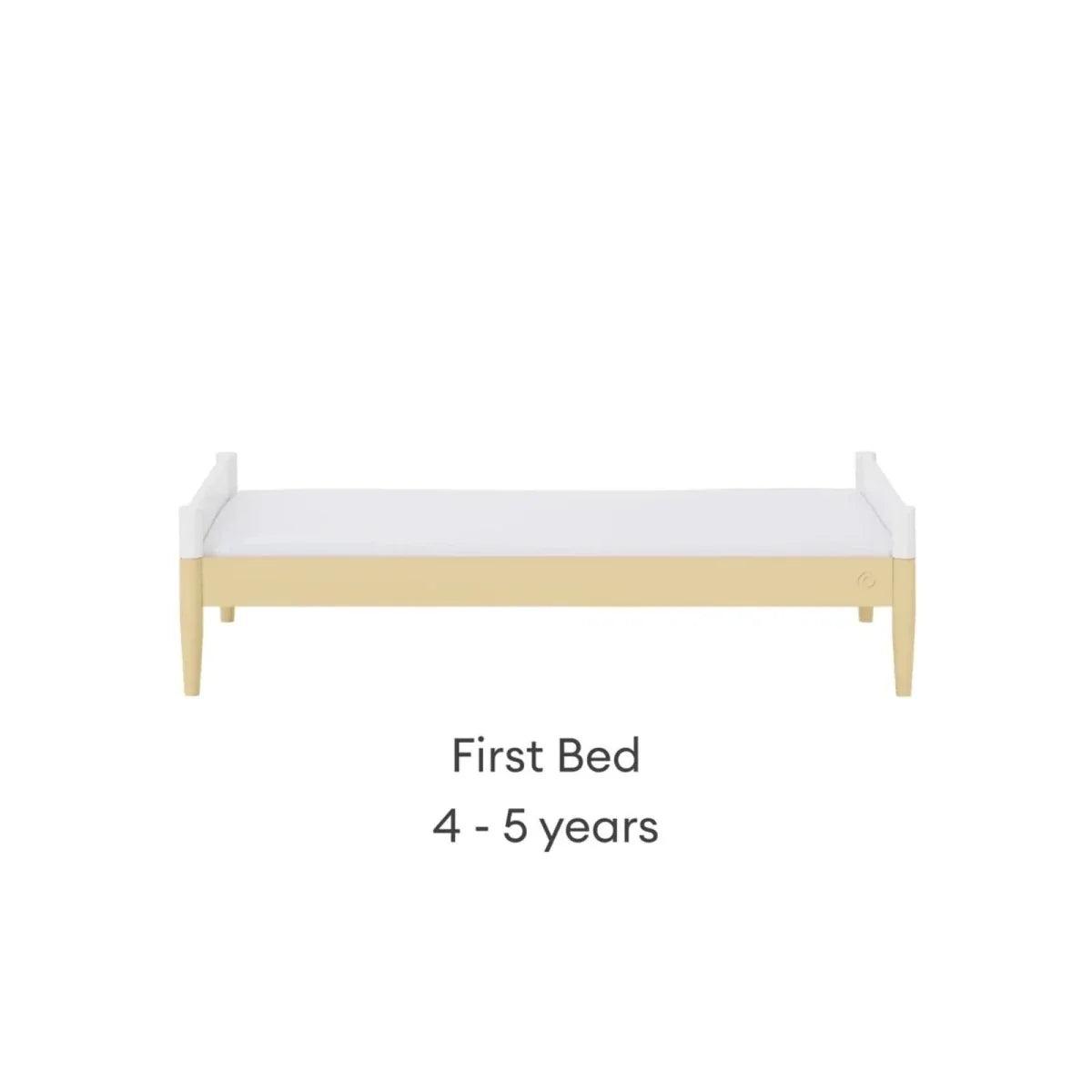 First bed with white side panels, primrose yellow trim, and light wood legs