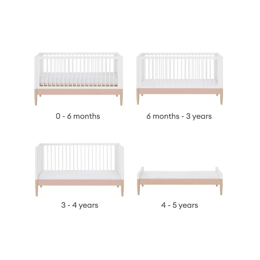 White convertible cot bed frame with powder blush rail and vertical slats