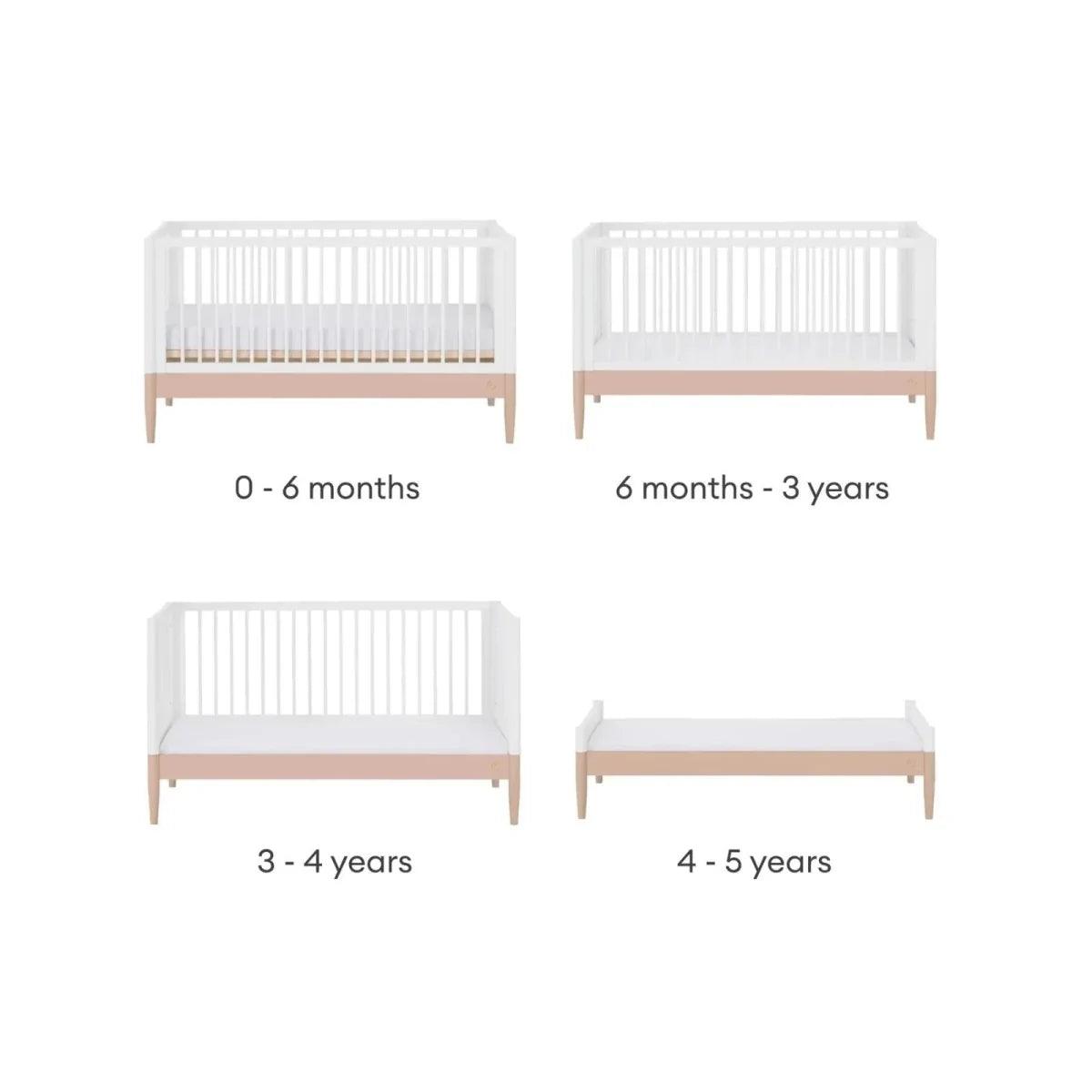 White convertible cot bed frame with powder blush rail and vertical slats