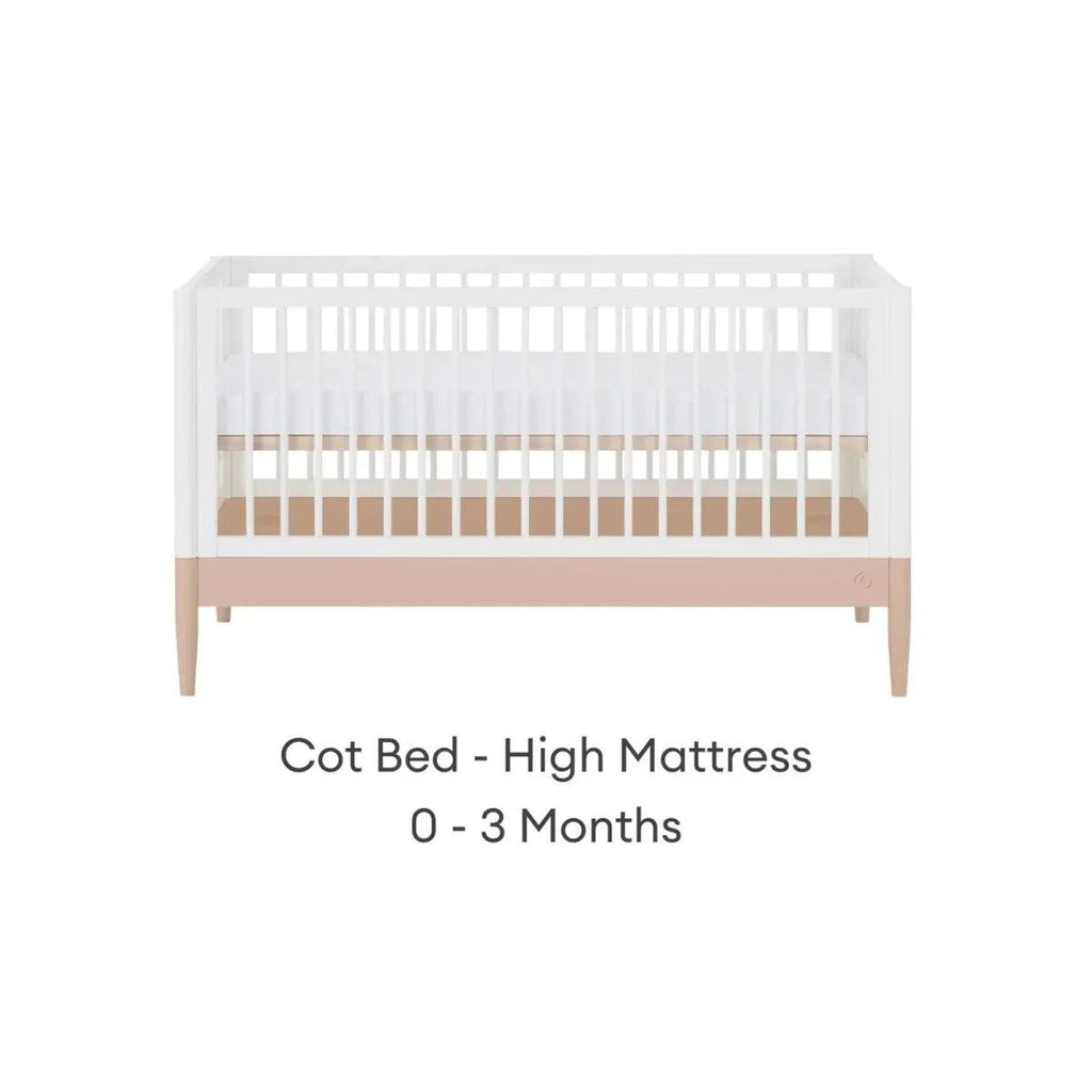 White cot bed with powder blush rail and vertical slats, high mattress position