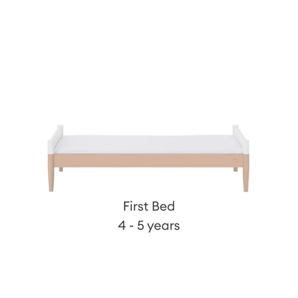White first bed with powder blush rail and short side panels