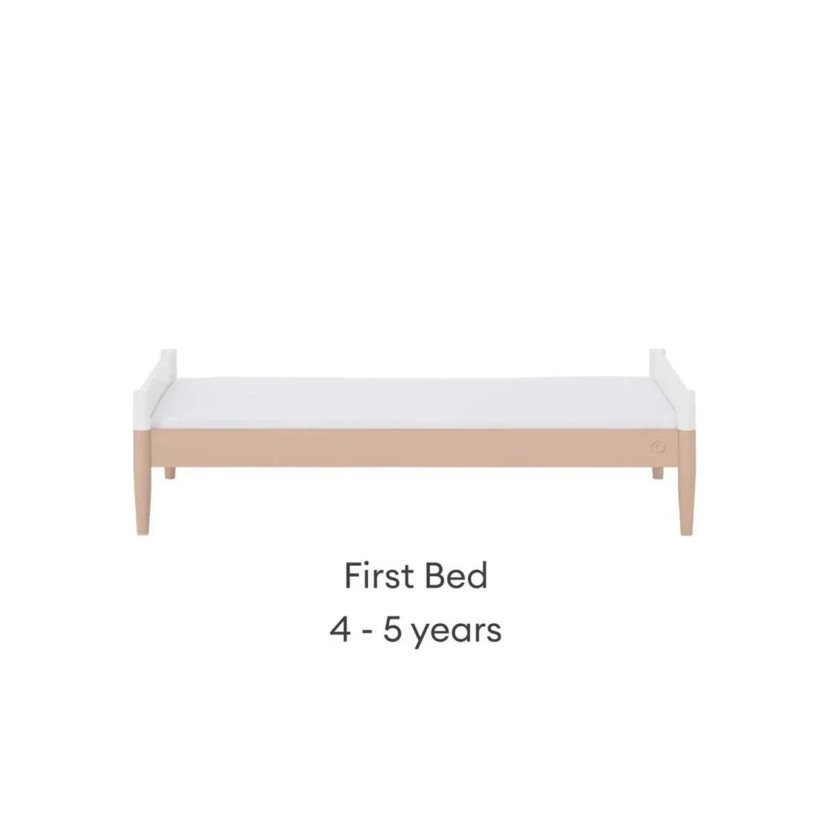 White first bed with powder blush rail and short side panels