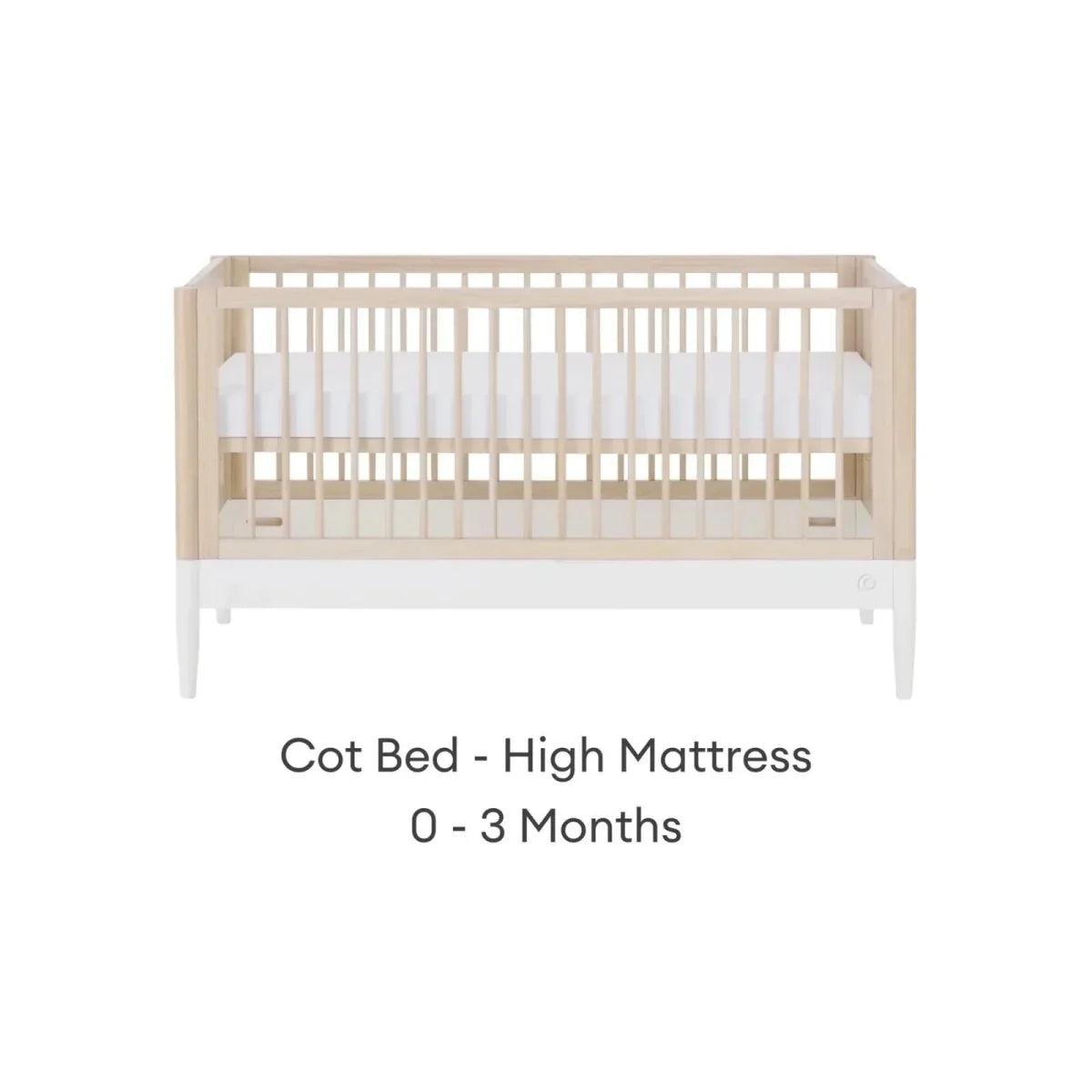 White and natural ash cot bed with high mattress position and vertical slat guardrails