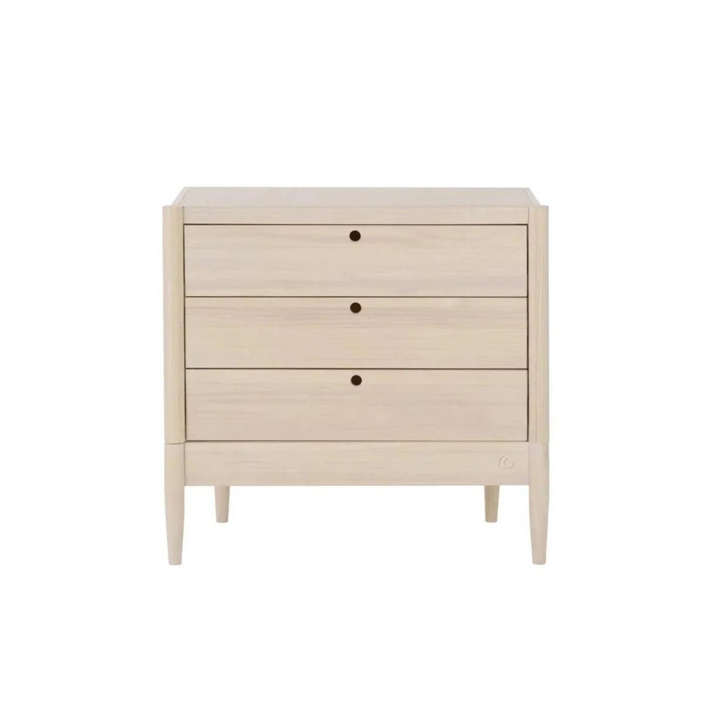 Light ash wood baby dresser with three horizontal drawers and round knobs