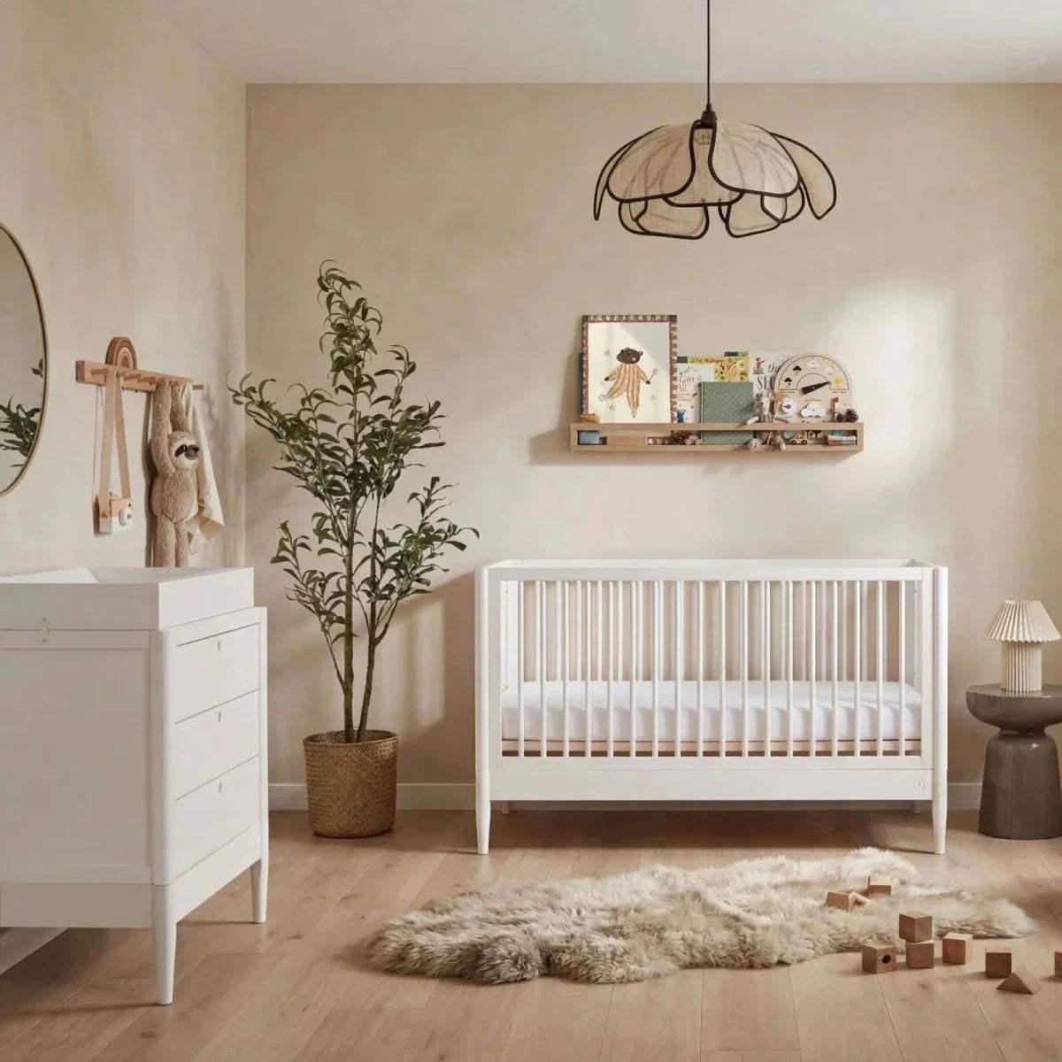 White baby dresser corner view with multiple drawers and gold knobs
