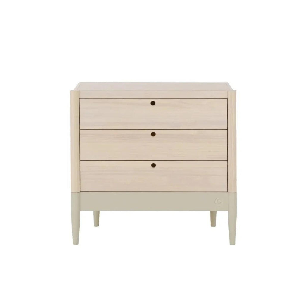 Light-wood baby dresser with three drawers and round dark knobs, front view