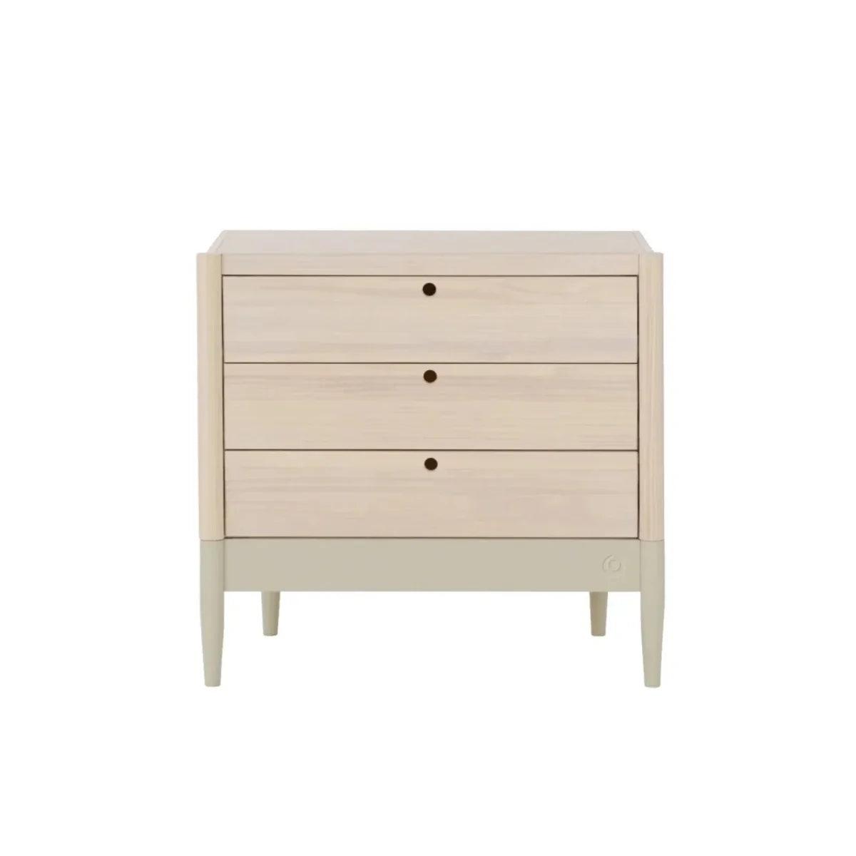 Light-wood baby dresser with three drawers and round dark knobs, front view