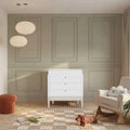 Baby 3-drawer dresser in white with desert-sage bottom panel and tapered legs