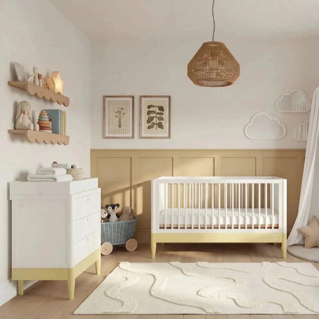 Two-tone baby dresser with three drawers and primrose yellow base, white body and legs