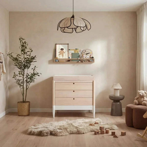 White and natural baby dresser with three drawers and dark round knobs