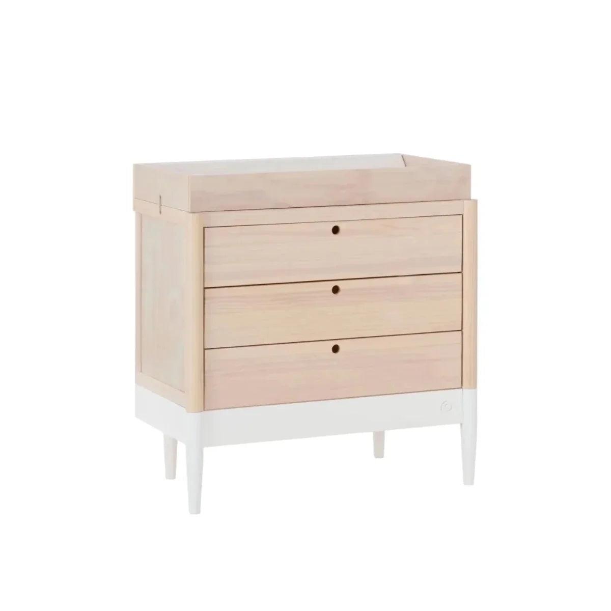White and natural baby dresser with three drawers, open top ledge, round knobs