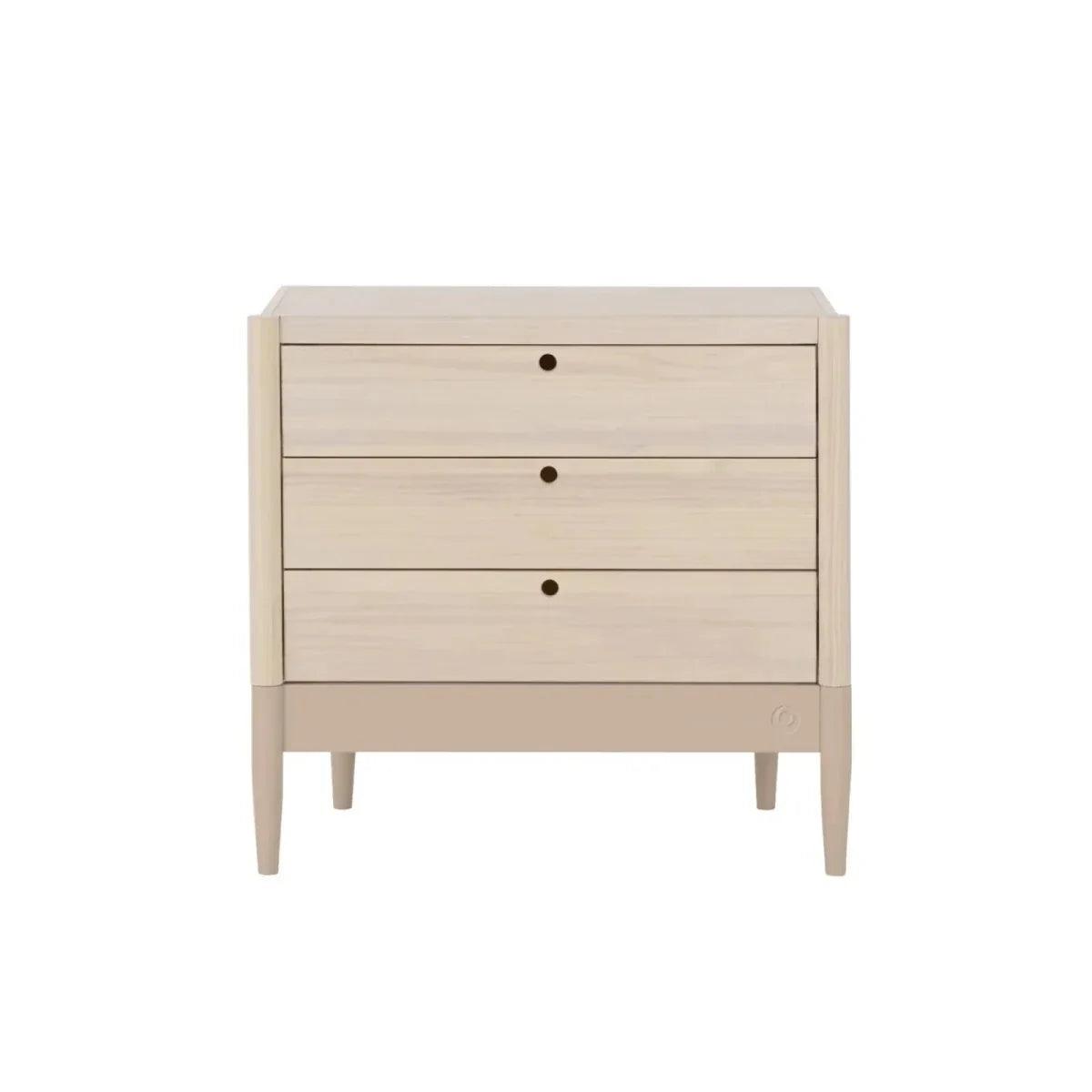 Baby dresser with four drawers in natural ash and powder blush trim, front view