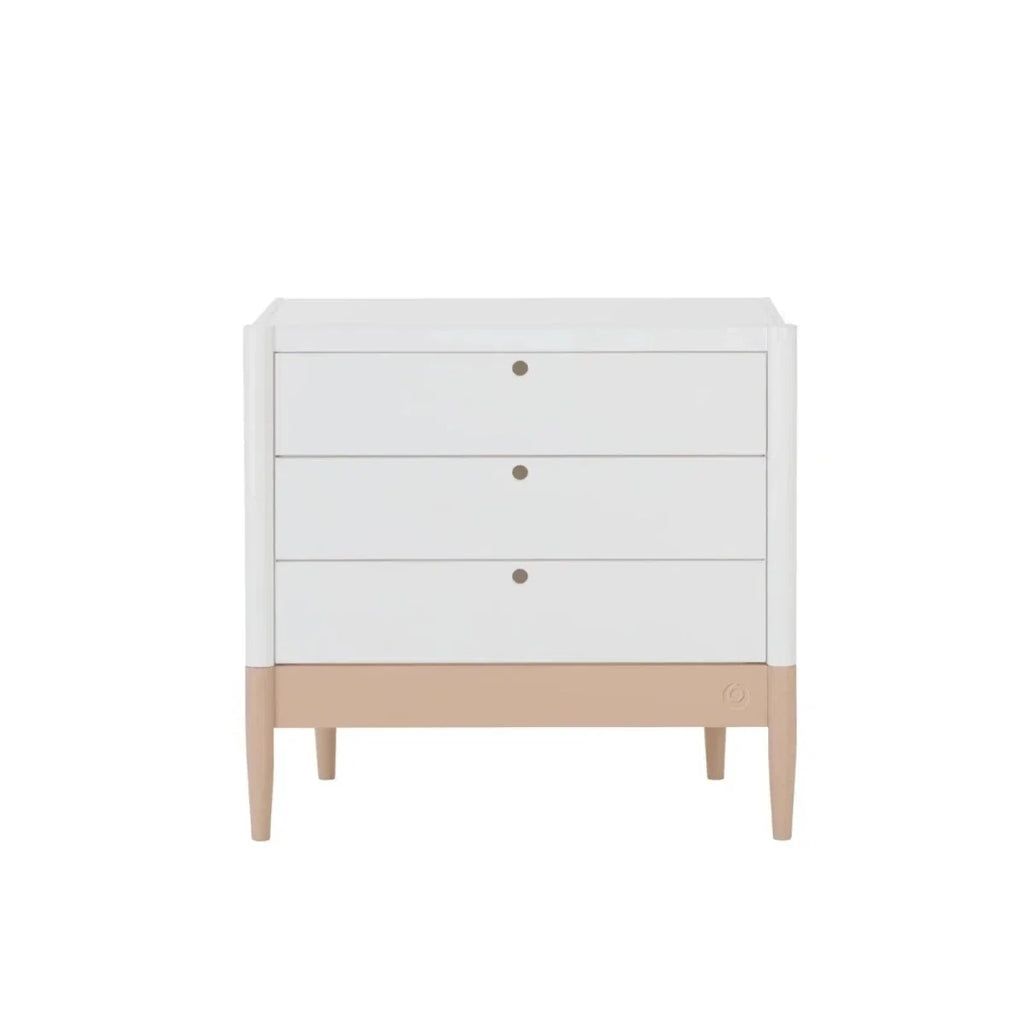 White baby dresser front view with three drawers, gold knobs, powder blush base