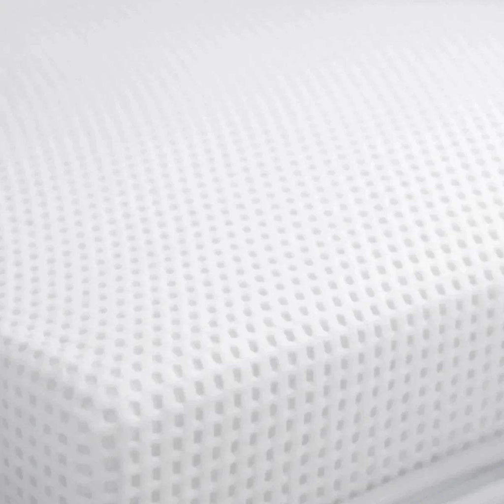 White mattress cover with textured fabric dots, visible weave detail