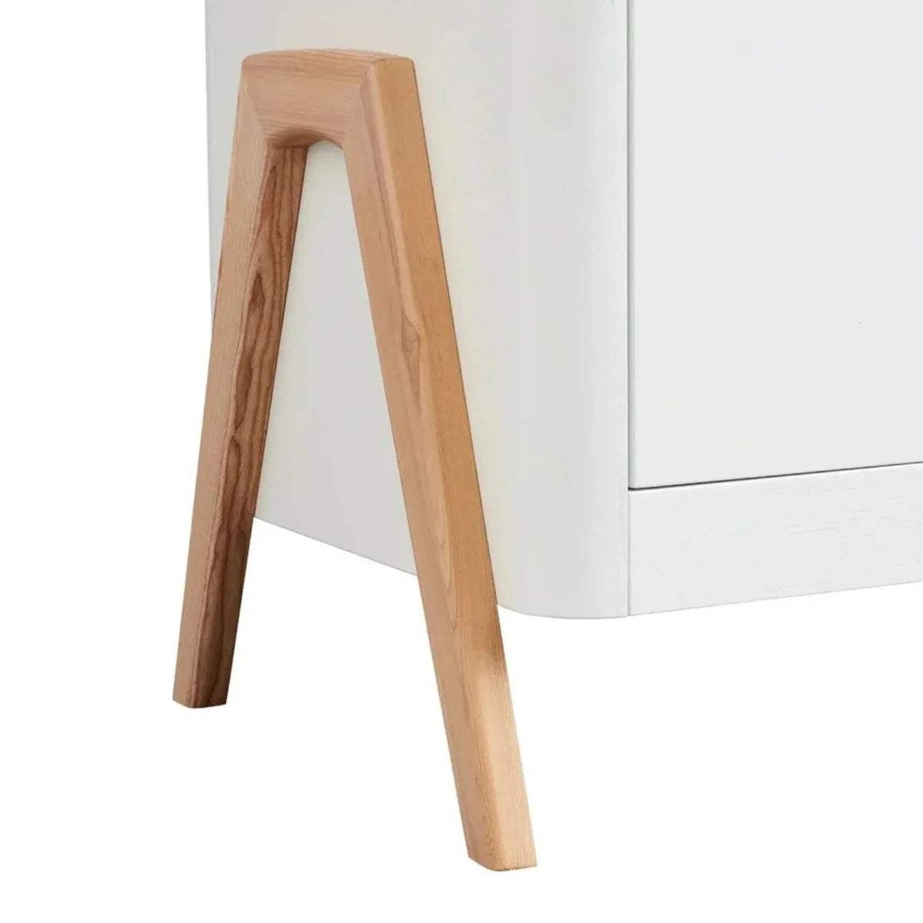 Natural wood bed leg with tapered shape attached to white frame