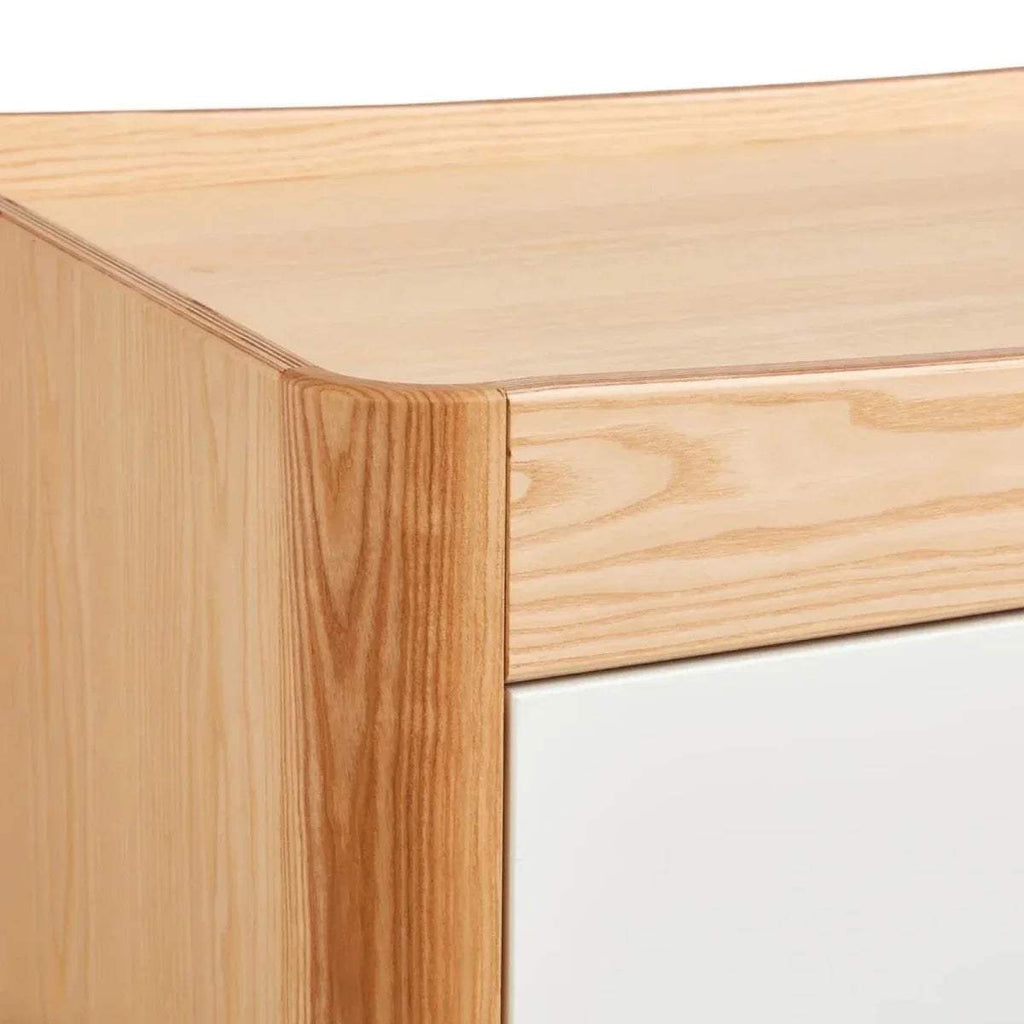 Close-up of natural wood bed frame corner and smooth joinery
