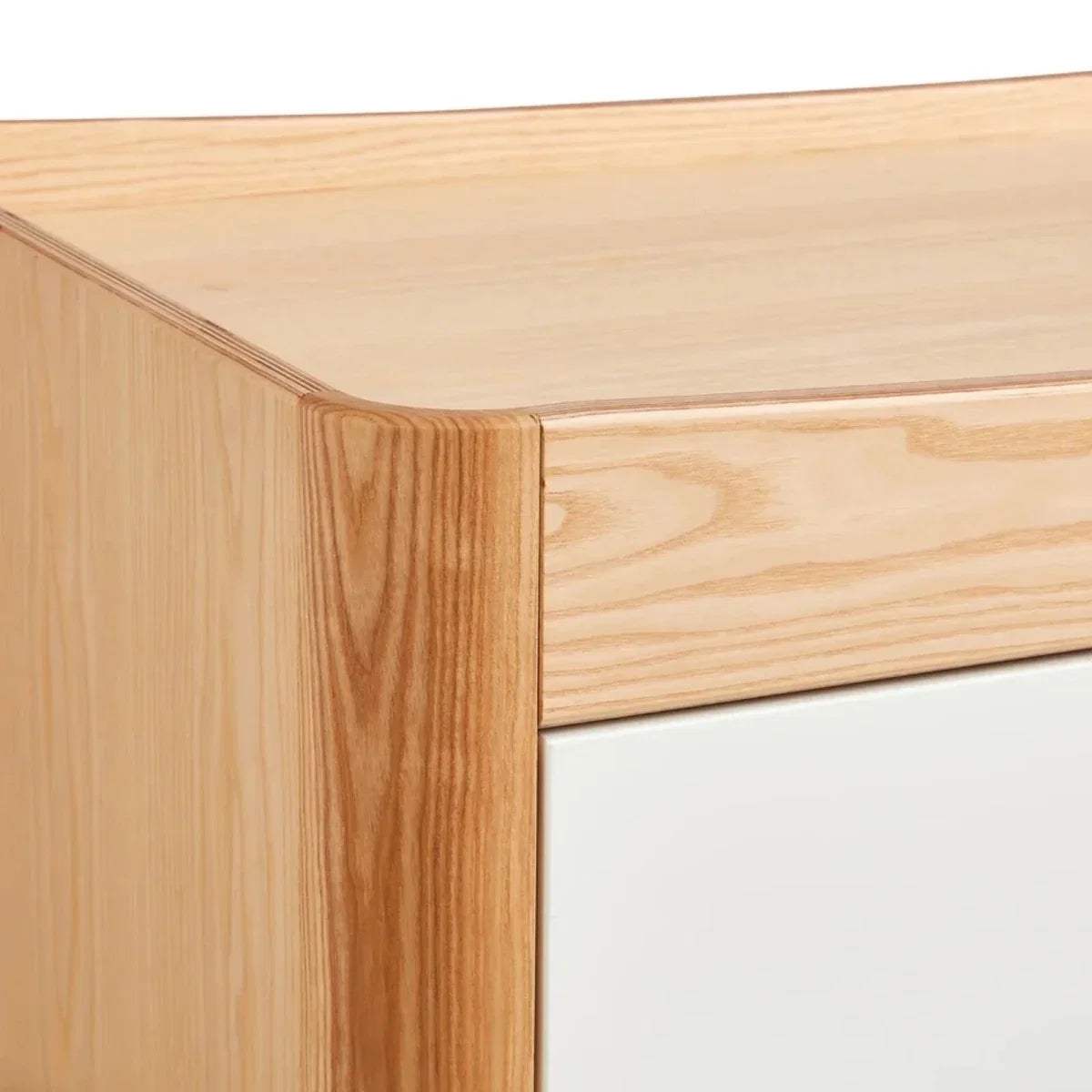 Close-up of natural wood bed frame corner and smooth joinery