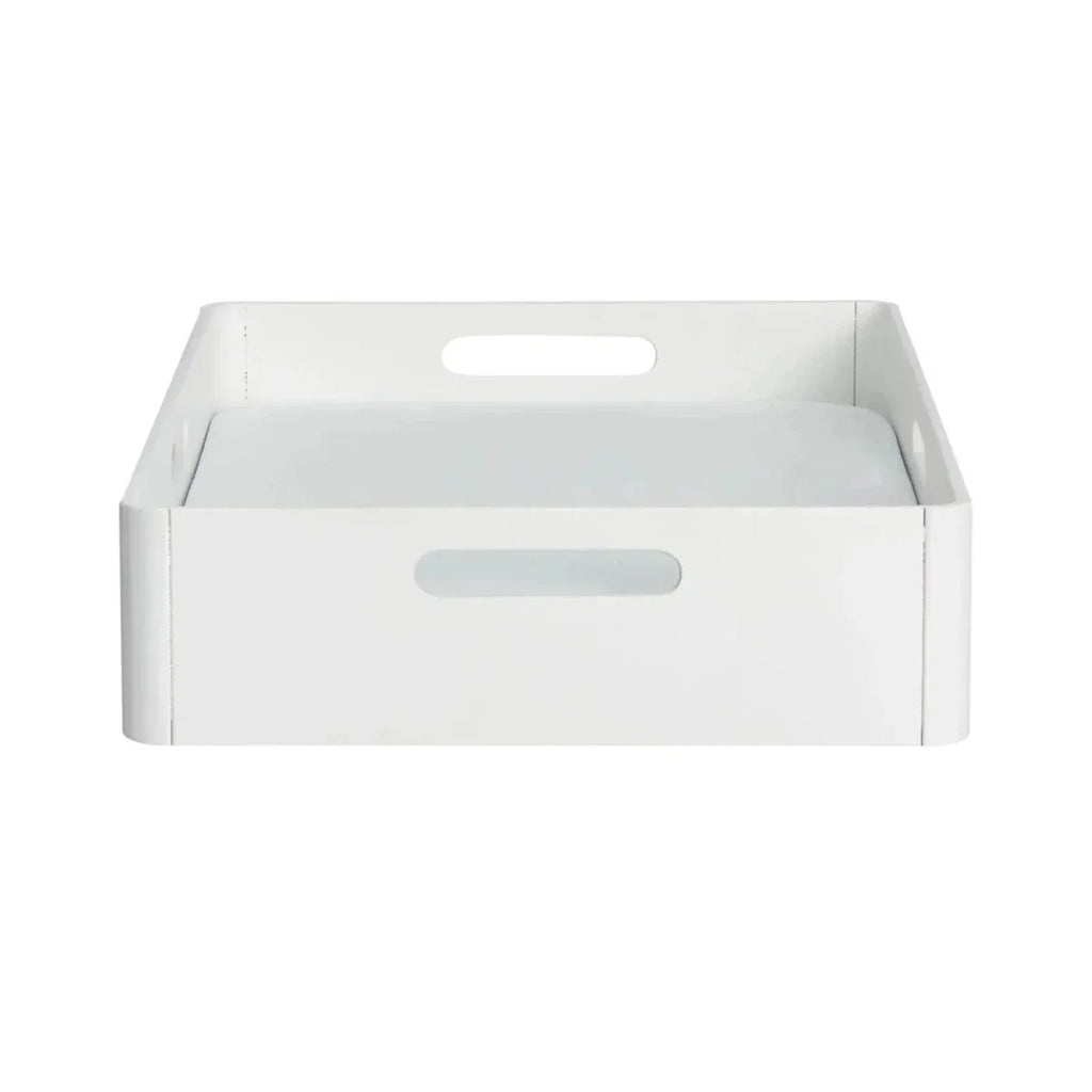 White plastic changing station tray with raised sides and center handle cutout