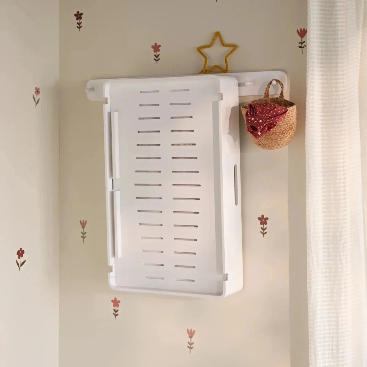 White wall-mounted changing station with slatted insert pad holder