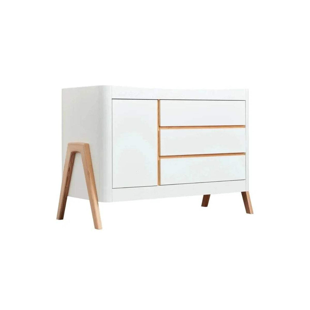 White baby dresser with two drawers, natural wood trim lines, and tapered legs.