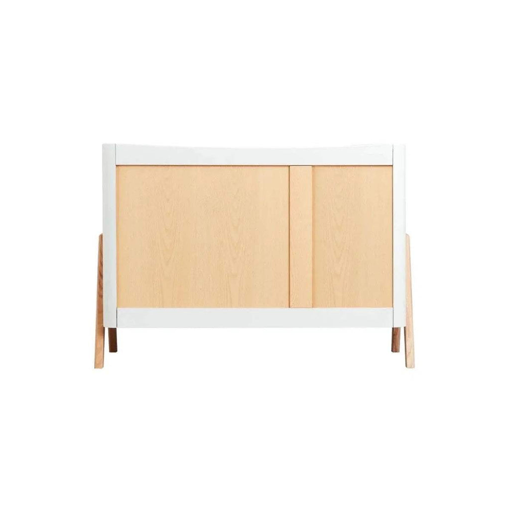 White baby dresser back panel with natural wood top section and corner legs.