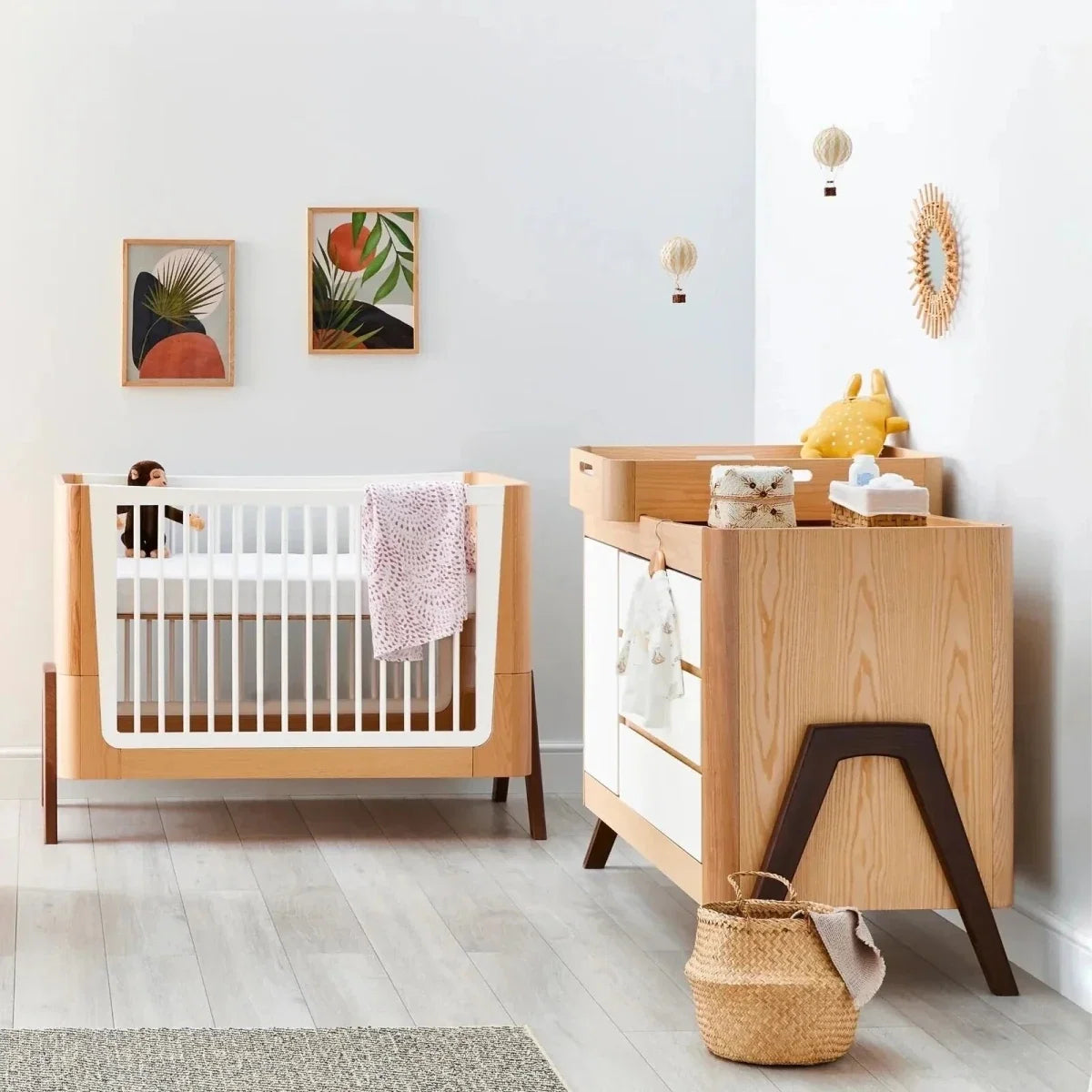 Light wood baby dresser with white drawer fronts and open top cubby
