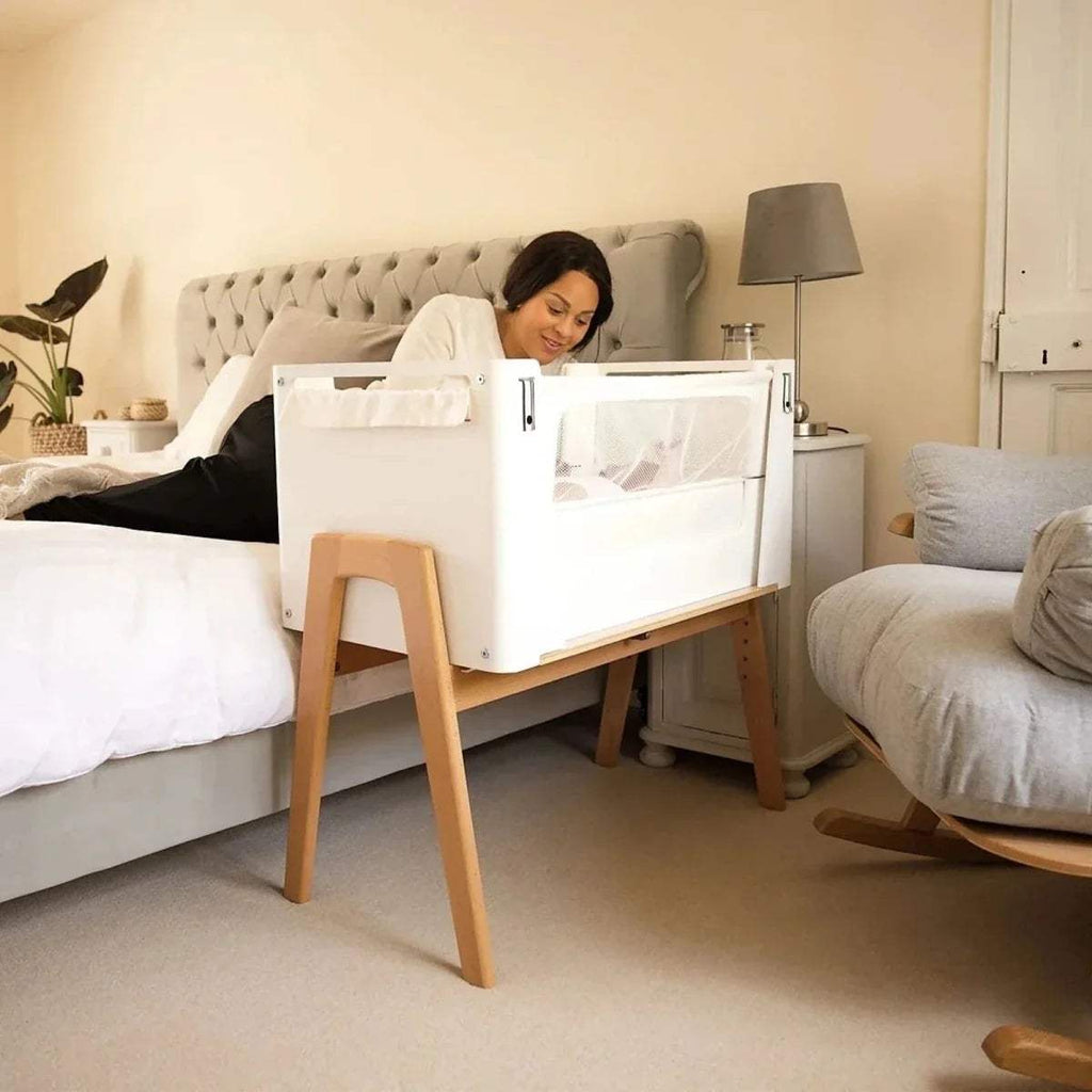 White fitted sheet on baby bedside crib mattress