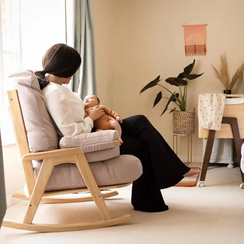 Gaia Baby Hera rocking chair with off-white upholstery and light oak rocker base