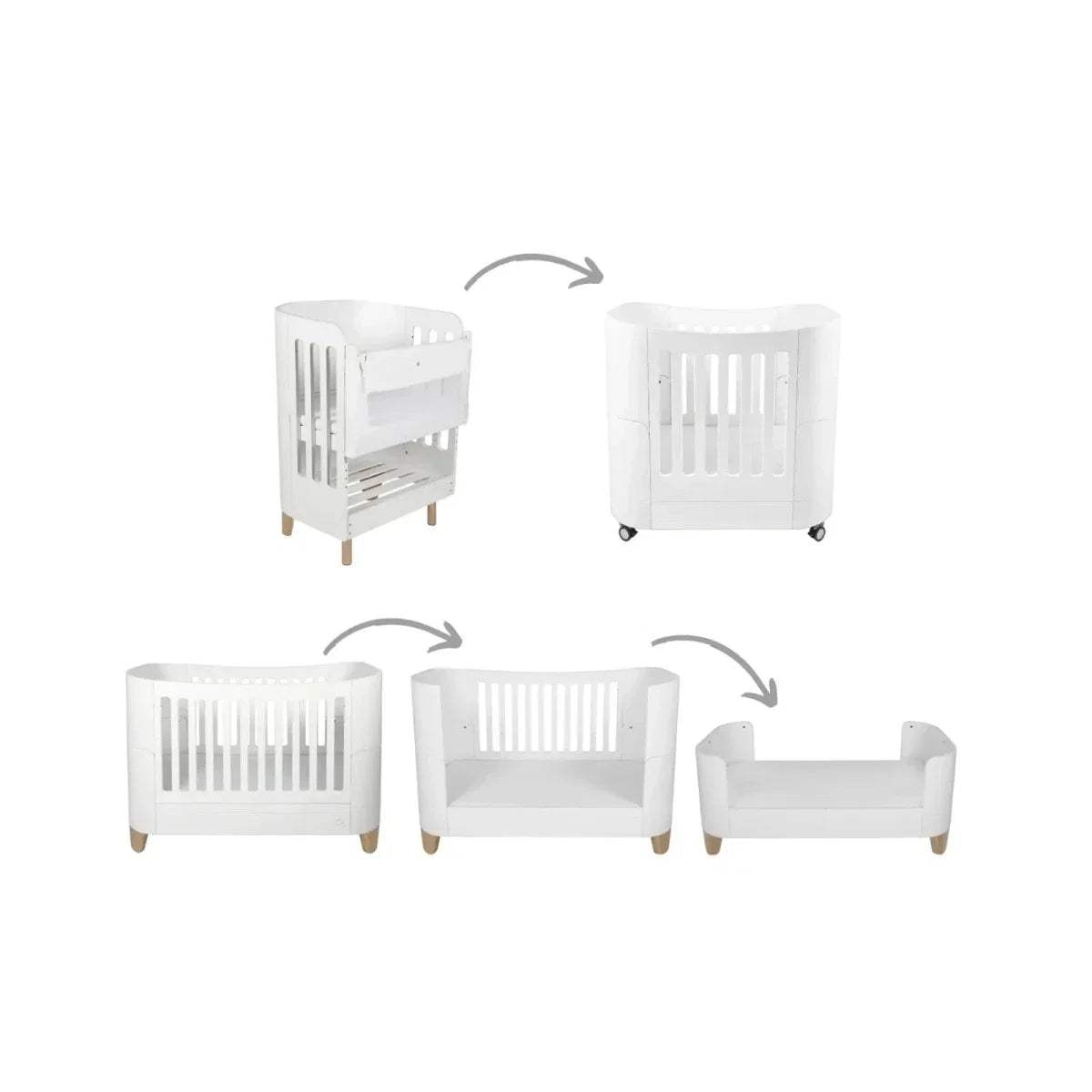 White baby cot bed with vertical slat sides and natural wooden feet