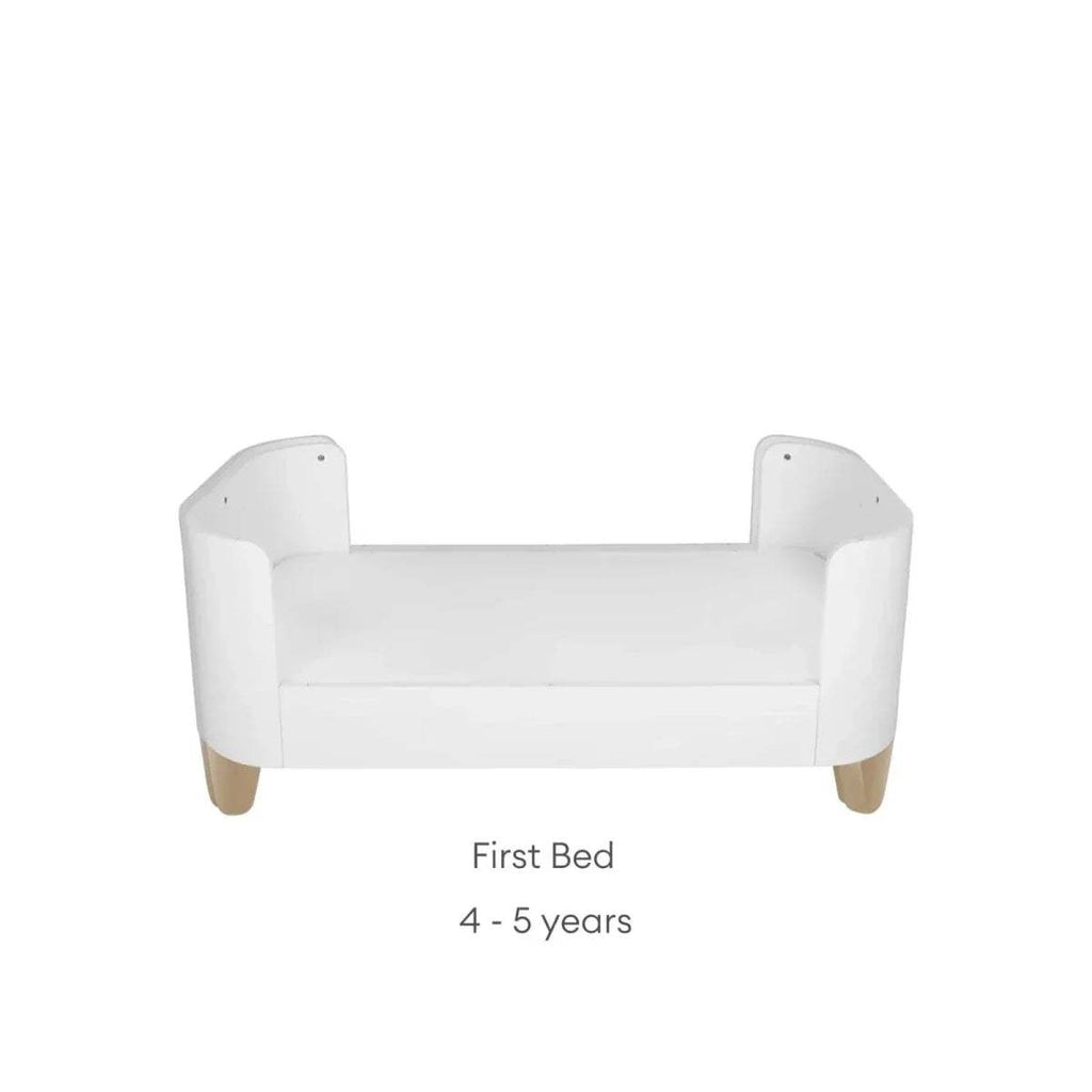 White first bed with open base, end guard panels, and natural legs
