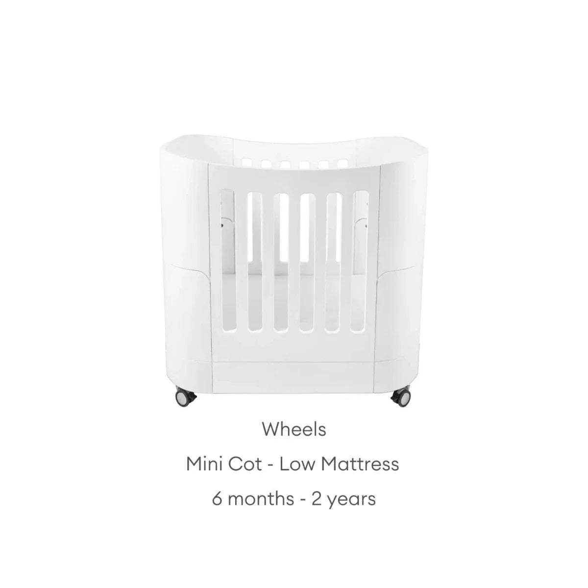 White mini cot with vertical slat guard and caster wheels