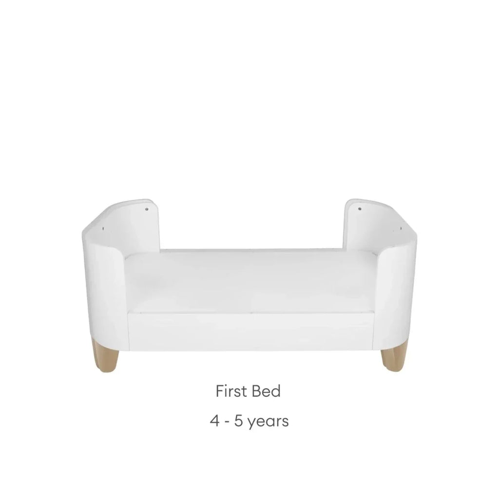 White first bed frame with curved end panels, smooth front rail, and natural wood feet