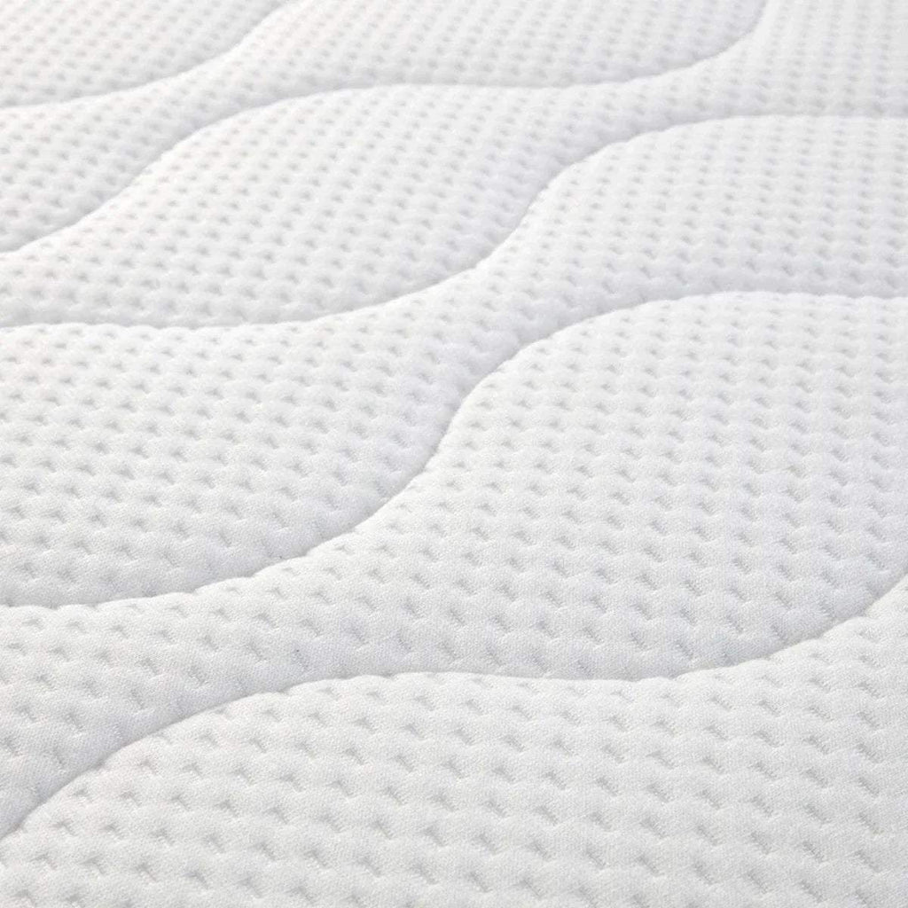White quilted cot bed mattress surface with raised wave channels