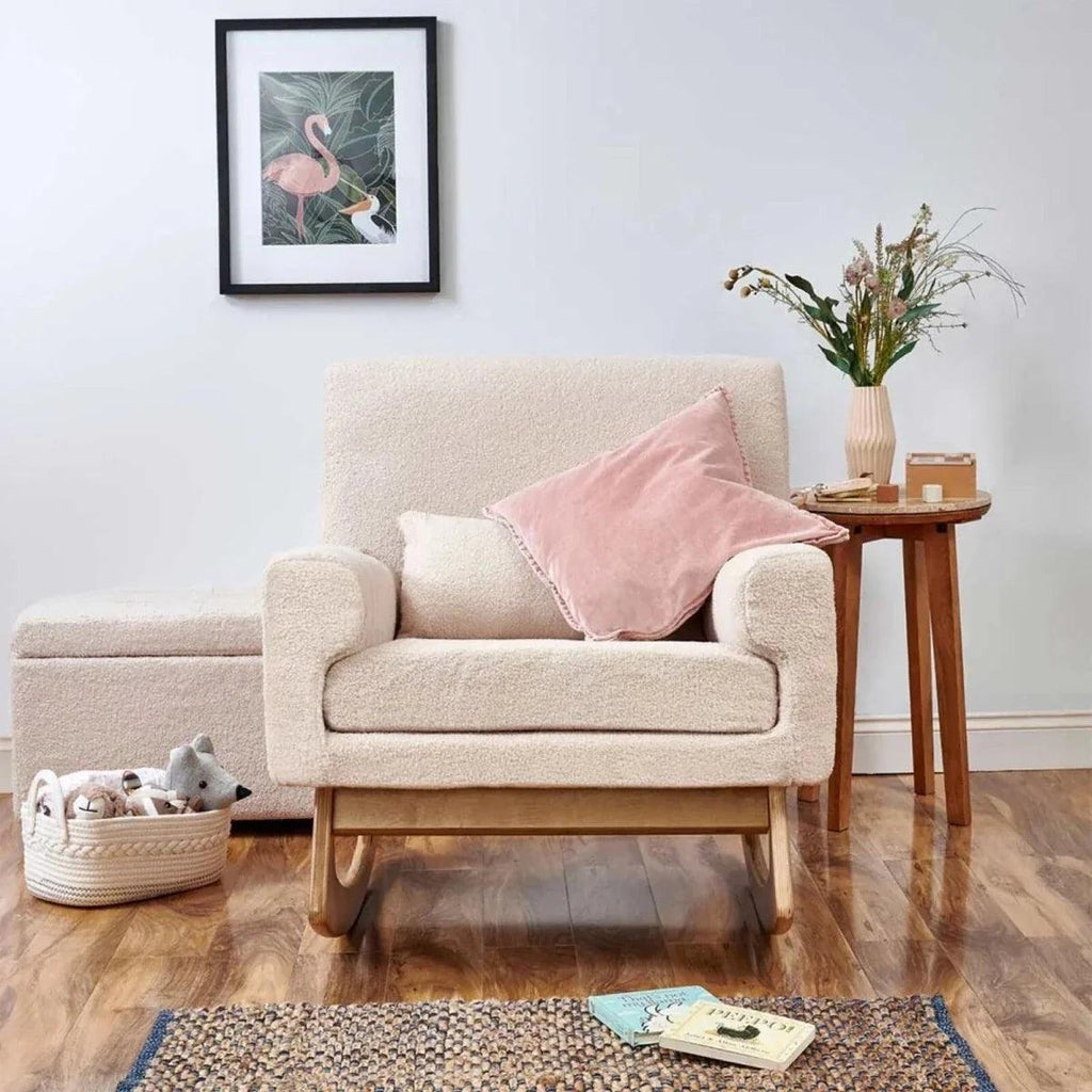 Nursing chair in biscuit boucle with square arms, seat cushion, and curved rocking base