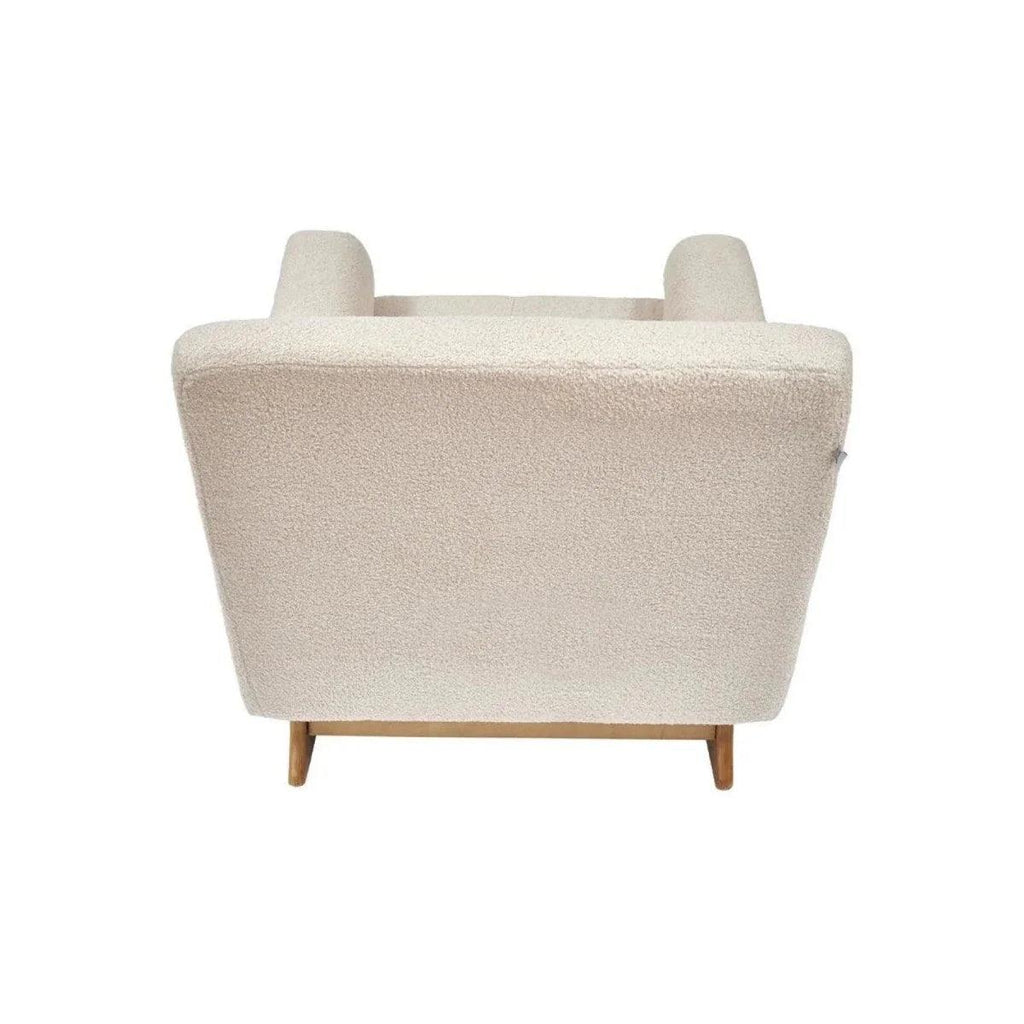 Nursing chair in biscuit boucle with wide back panel and two rounded headrest cushions