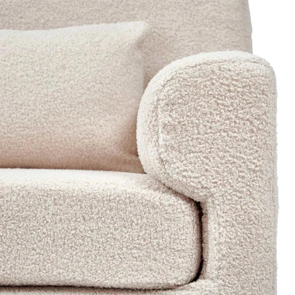 Biscuit boucle nursing chair arm and seat cushion with textured fabric close-up